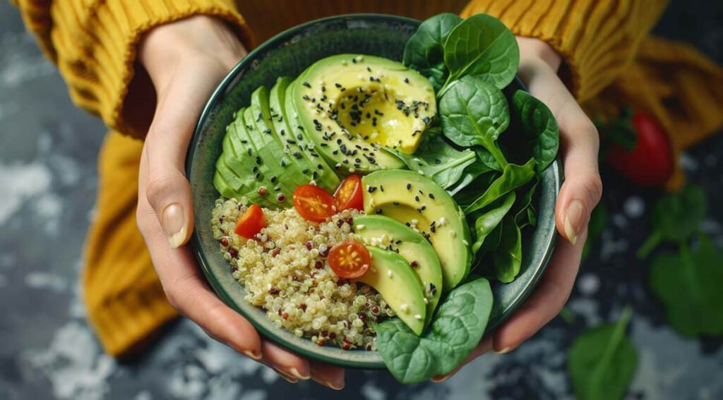 A woman holding a bowl of quinoa, avocado, and spinach Salad