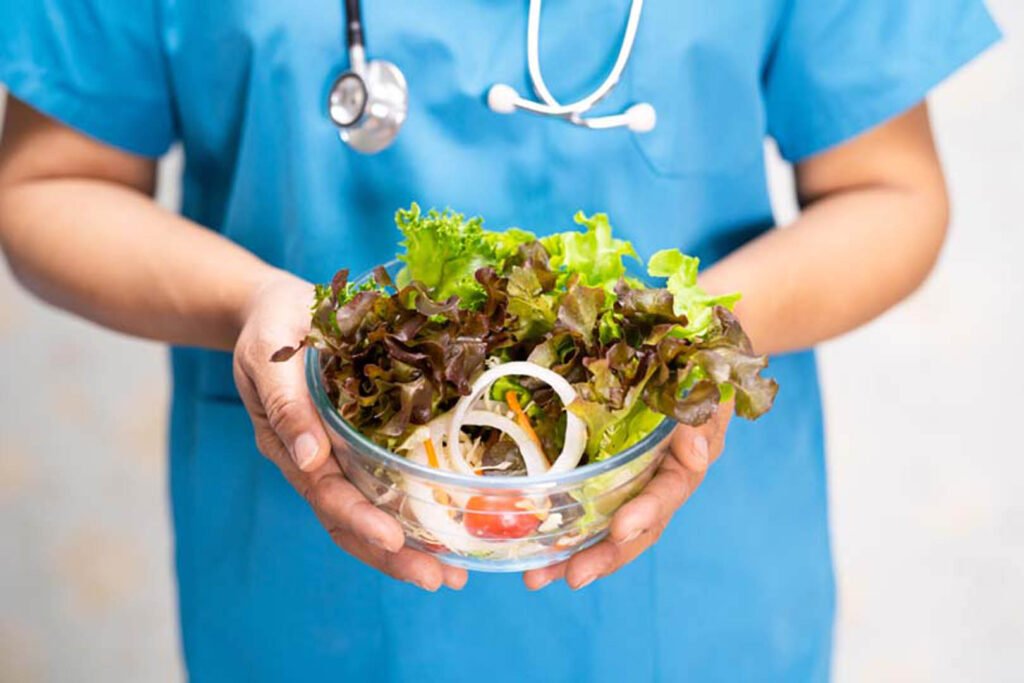 Nutritionist doctor holding various healthy fresh vegetables